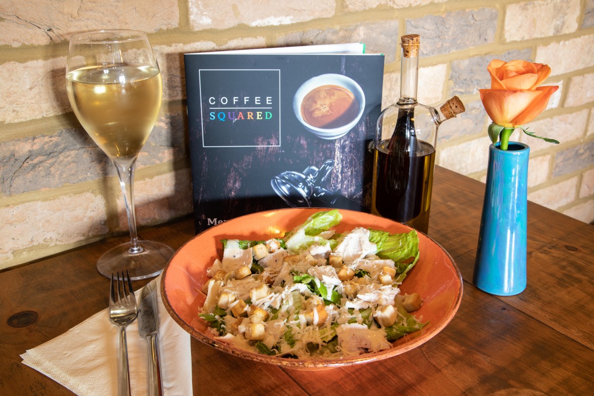 Caesar salad and a glass of wine